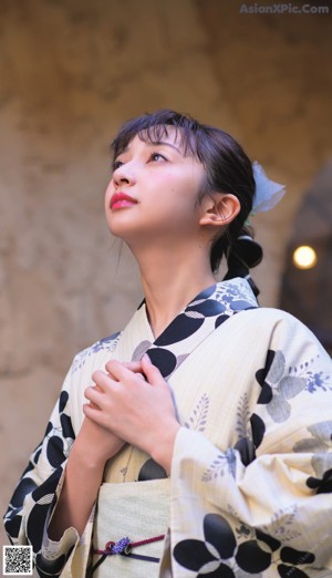 A woman in a red kimono with a flower in her hair.