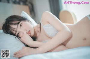 a woman in a white lingerie posing for the camera