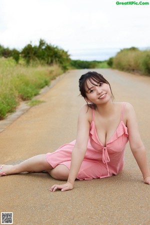 A woman in a bikini standing on a beach.