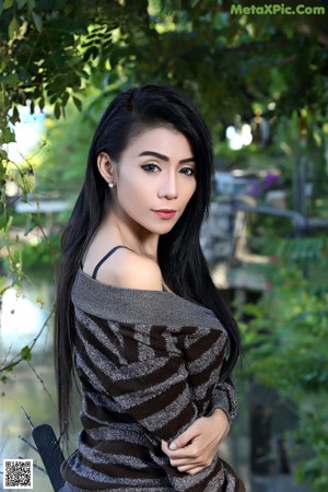 A woman in a black lingerie sitting on a bench.