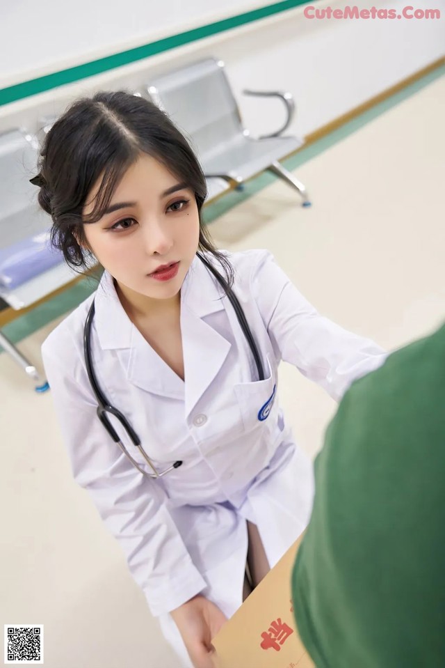 a woman in a white lab coat is talking to a doctor