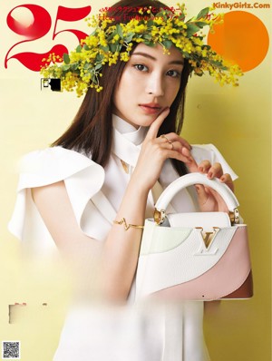 A woman holding a bunch of yellow flowers.